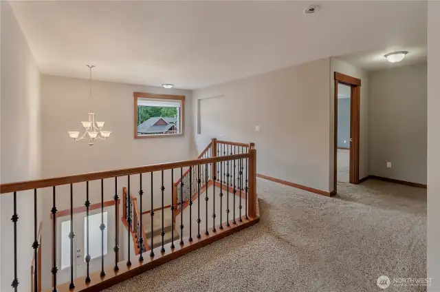 Landing at top of stairs overlooks the vaulted entry.