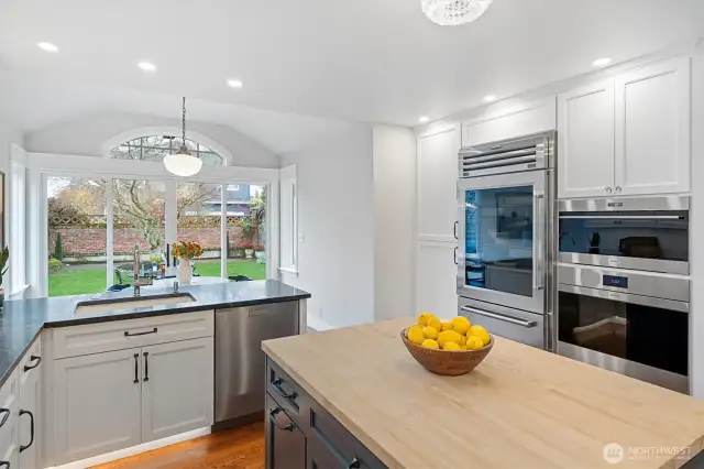Outfitted with a Wolf speed oven/microwave, a Wolf convection oven, and a Sub-Zero commercial-grade stainless steel refrigerator, the kitchen delivers exceptional performance with premium design.