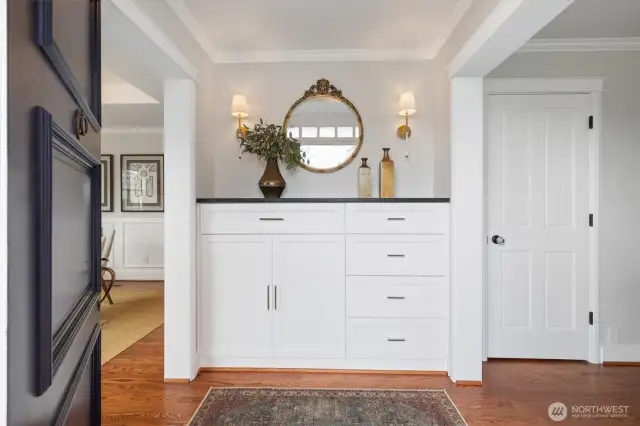 Custom cabinetry with Granite Ebony/Negresco Honed countertop, Camille Sconces by Suzanne Kasler, coffered ceiling with Antique-Burnished Brass with Alabaster stone flush Mount light and an Antique Mirror