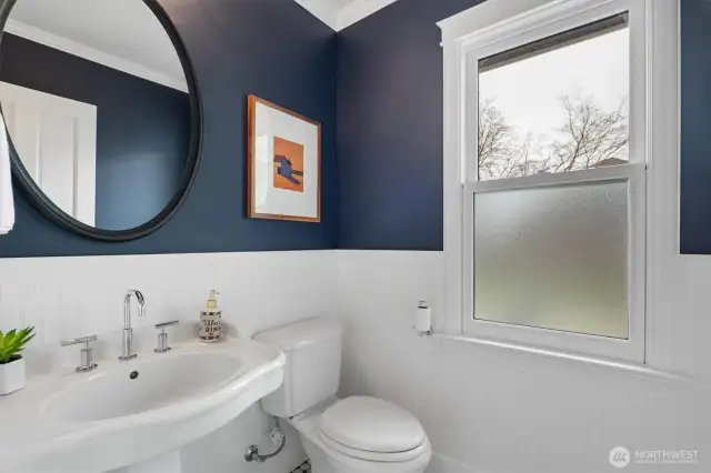 Main floor powder room.  Marble Mosaic tile, Wainscot Beadboard, Antique Brass Shelby Sconce over pedestal sink.