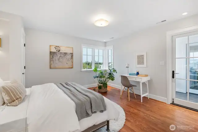 The second upstairs bedroom offers direct access to the east-facing deck, as does the first bedroom, creating a seamless connection to outdoor living from both rooms.
