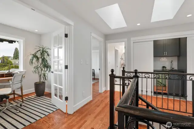 From the landing, looking west toward the office or nursery, this view captures the natural light and intentional flow of the upper level.
