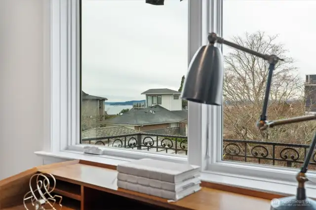 The office or nursery enjoys a tranquil southwest-facing view, with a glimpse of Puget Sound framed by treetops and neighboring rooftops. Natural light fills the space throughout the day, making it an inspiring setting for focused work or a calming retreat for rest and play.