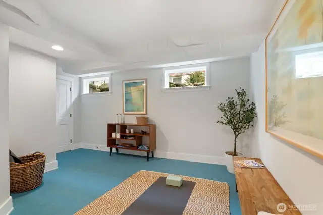 This light-filled lower-level room offers flexible use as a home gym, yoga studio, or creative space. Outfitted with eco-friendly Marmoleum MCT flooring, it’s both comfortable and durable underfoot. Two windows provide natural light, while a large closet adds valuable storage. Clean lines, fresh finishes, and thoughtful lighting create a calm, functional extension of the living space.
