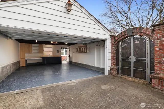 The spacious two-car garage features an Infratech radiant heater, built-in workbench, sink with Grohe faucet, and a new insulated Wayne Dalton 6600 Somerset carriage-style door with custom opener. Additional attic storage provides convenient overflow space for seasonal or infrequently used items.