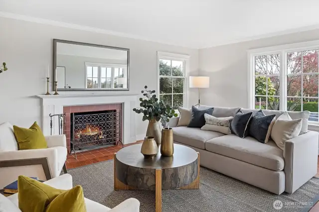 A traditional wood-burning fireplace with a classic mantel anchors the living room, adding warmth and architectural charm.
