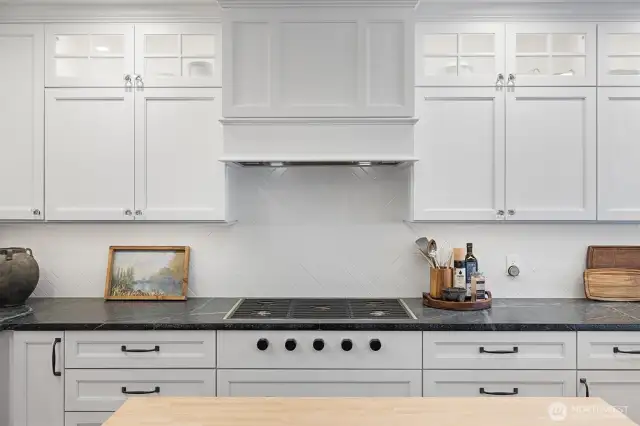 Wolf 5-gas burner cooktop integrated into honed black Soap Stone slab Countertop