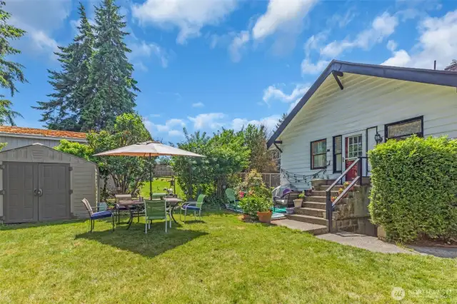 Backyard with lovely entertaining space. Shed stays