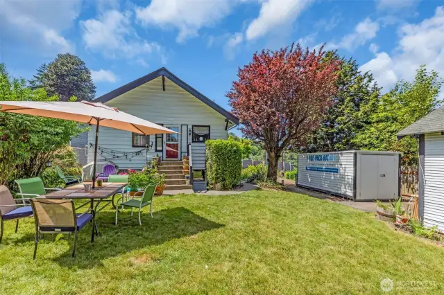 Backyard with lovely entertaining space. Shed stays