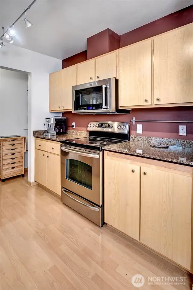 Stainless steel appliances and stone countertops. Here there is plenty of cabinet and counter space.
