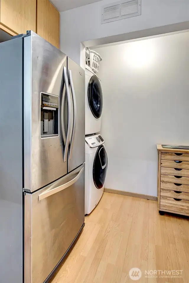In-unit laundry area off the kitchen with additional pantry/storage space