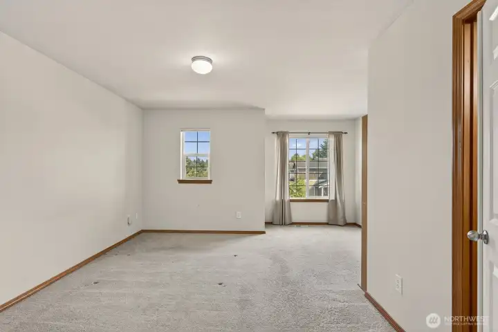 Roomy primary bedroom with double doors