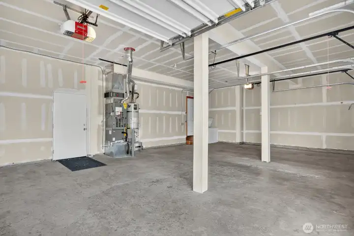 Three car garage with door to the side yard
