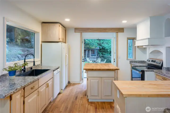 Butcher block island, functional kitchen space, and plenty of counters to prep food!
