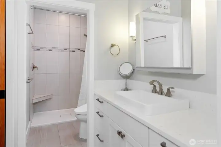 Primary bathroom. The Sellers are replacing the shower curtain with a sliding glass shower door. Not shown- nice walk-in closet.