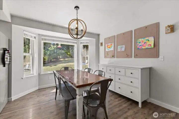 Dining area w/ windows looking out to the backyard.