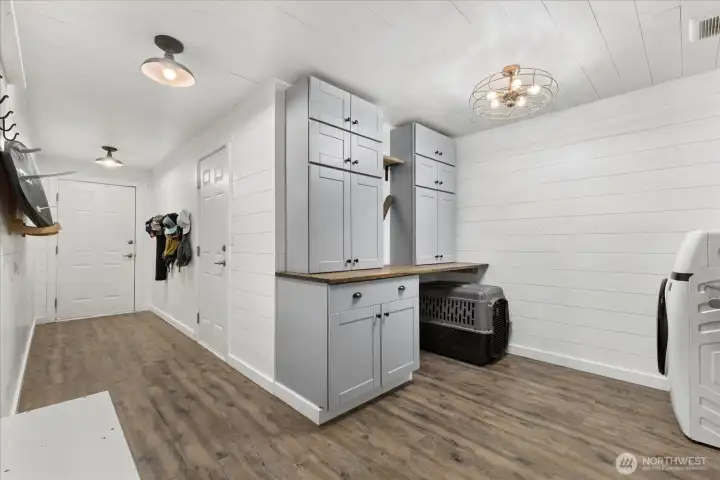 New ~permitted mud/laundry room addition. w/ Lots of storage. The doors lead to the garage, carport & dog run.