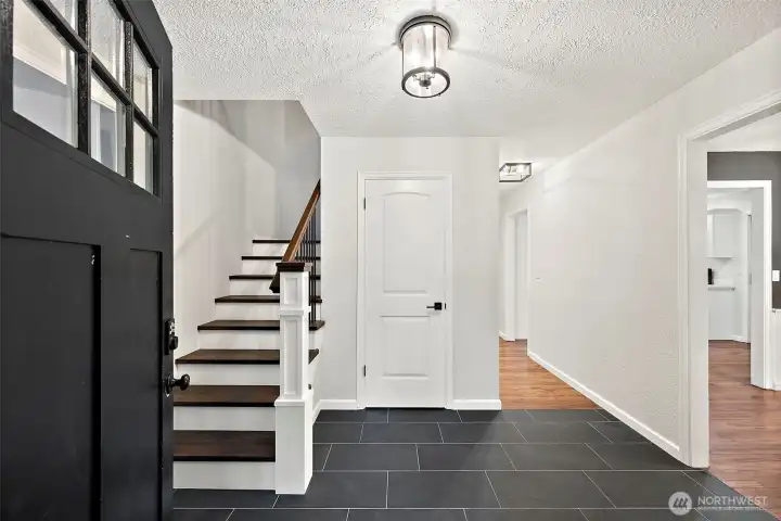 Step inside to a tiled entry way leading to dining and living rooms on either side and the staircase leading to upstairs bedrooms.