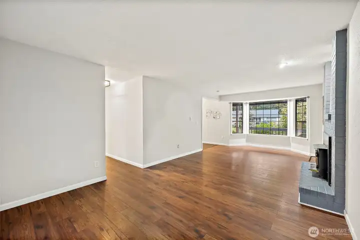 Living room off entryway to the left looks out to front yard on one end and out to backyard on the other end and walking in to the kitchen as well.