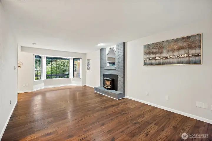 Living room off entryway to the left looks out to front yard on one end and out to backyard on the other end.