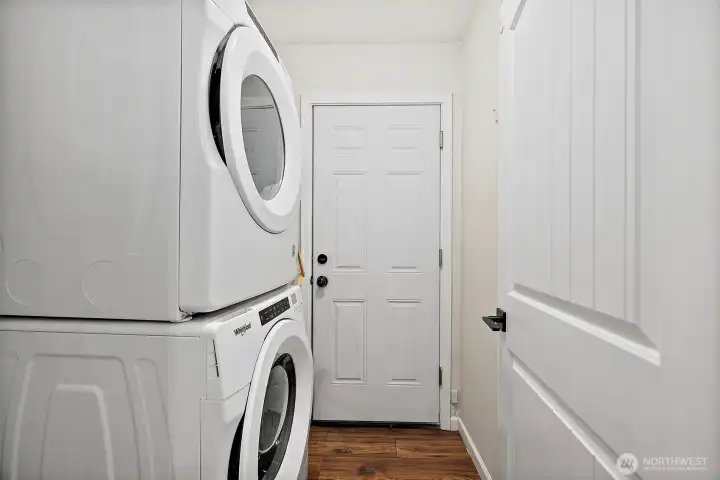 Laundry room on main floor with stacked front-load washer & dryer