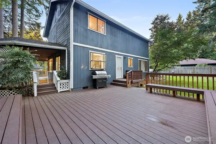 Huge back deck perfect for summer parties, and unwinding on the weekends. Back access of laundry room as well as side sliding door off kitchen.
