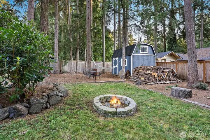 Spend summer nights around the backyard fireplace. Chill in a hammock between the trees.
