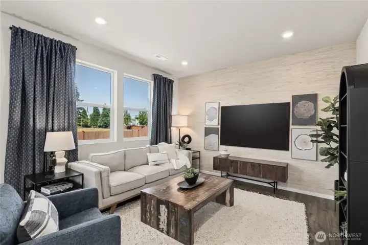 Open great room with large windows for natural light. Actual home is under construction. Colors, materials, and features may vary. See site agent for details.