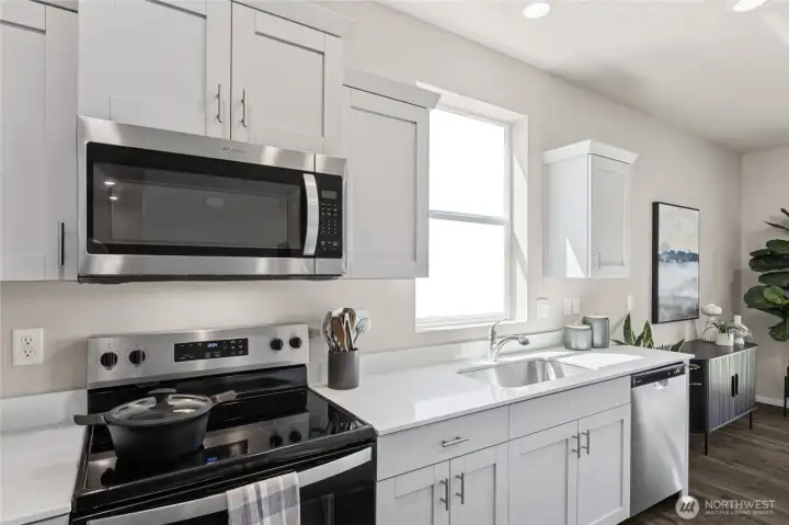 Beautiful modern kitchen with stainless-steel appliances, shaker style cabinets with soft close doors, and quartz countertops all included! Actual home is under construction. Colors, materials, and features may vary. See site agent for details.