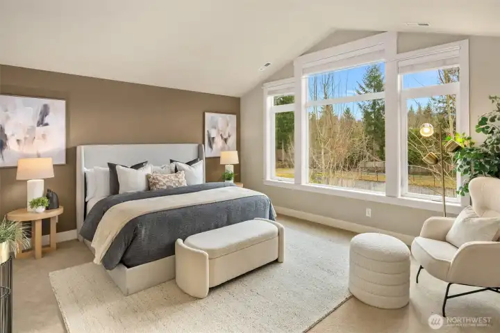 Stately primary w/ a 5-piece spa ensuite & a huge walk-in closet and peaceful mountain and pond view.