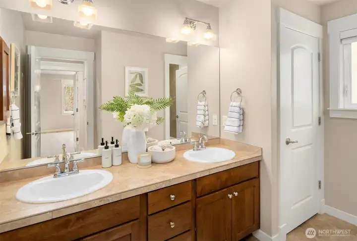 2nd floor full bath with double sink and a separate shower room that can be locked for easy sharing!