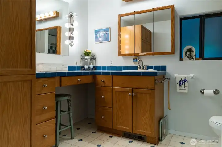 Large primary bathroom featuring higher countertops for comfort.