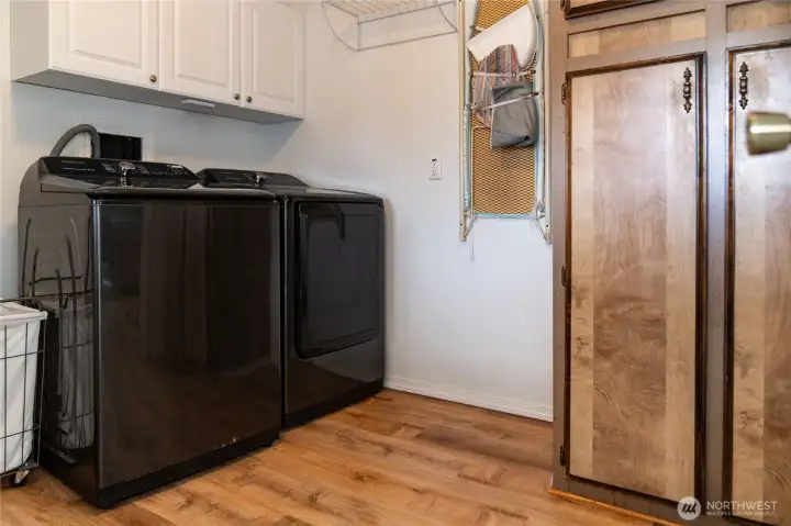 Laundry room with ample storage.