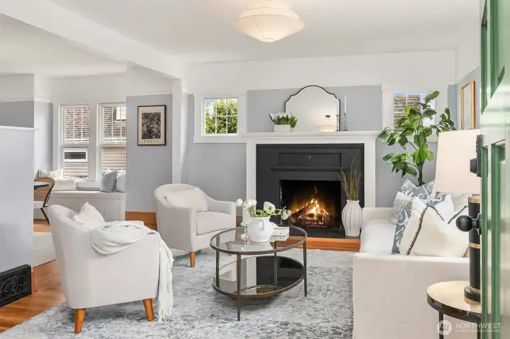 Large living room with fireplace and large windows.