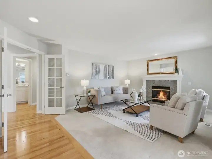 Another set of French doors lead to a more casual living area with a cozy gas fireplace