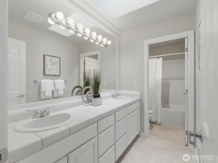 Guest bath with double sinks-separate tube area and skylights