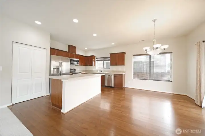 A large eat-in kitchen with hardwood floors and stainless steel appliances A large eat-in kitchen with hardwood floors and stainless steel appliances
