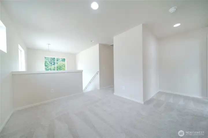 Loft space in front of the primary bedroom with brand new carpet throughout Loft space in front of the primary bedroom with brand new carpet throughout