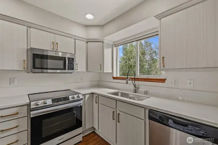 Updated kitchen with quartz countertops. New Range and refrigerator.
