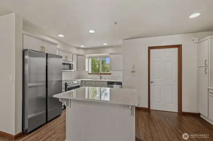 Updated kitchen with quartz countertops. New Range and refrigerator.