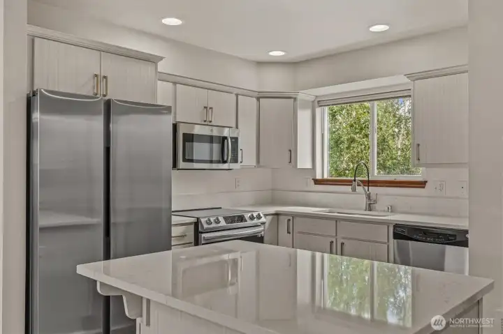 Updated kitchen with quartz countertops. New Range and refrigerator.