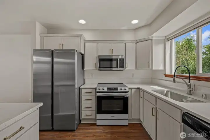 Updated kitchen with quartz countertops. New Range and refrigerator.