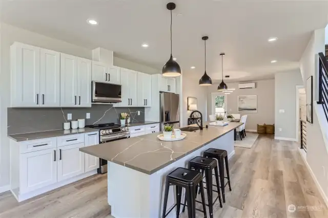 Kitchen with eating space for 5. Custom quartz  (Unit C Staged Photo)