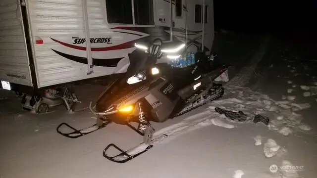 2 Polaris snowmobiles included.