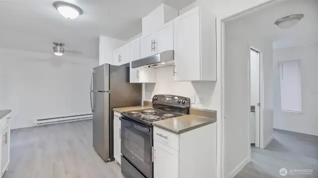 Perfectly positioned kitchen allows flow to all main living areas & the entries to the unit.