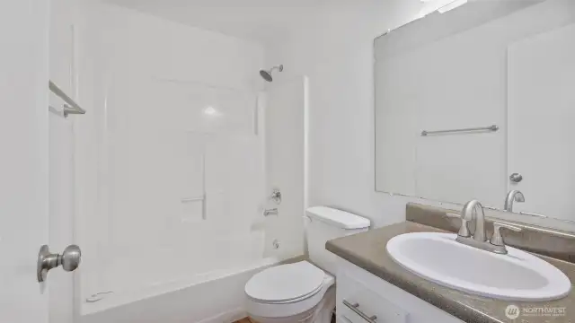 Adjacent to the utility closet & guest bedroom is the full bath.