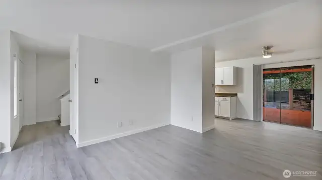 Spacious living room with beautifully updated LVP flooring that run throughout the main living space.