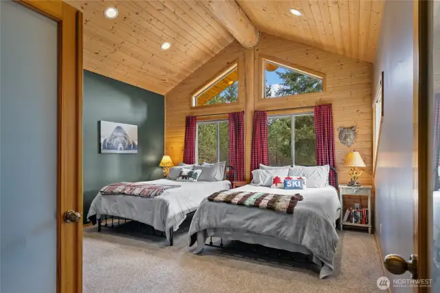 Large upstairs bedroom with plenty of sleeping space.