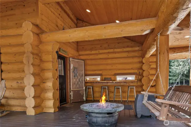 The side porch area completely covered with a fire pit and even a hot cocoa bar, perfect for year round enjoyment!