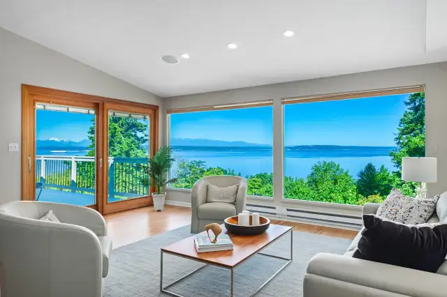 The living room has vaulted ceilings, refinished hardwood floors, access to the spacious deck and endless views.